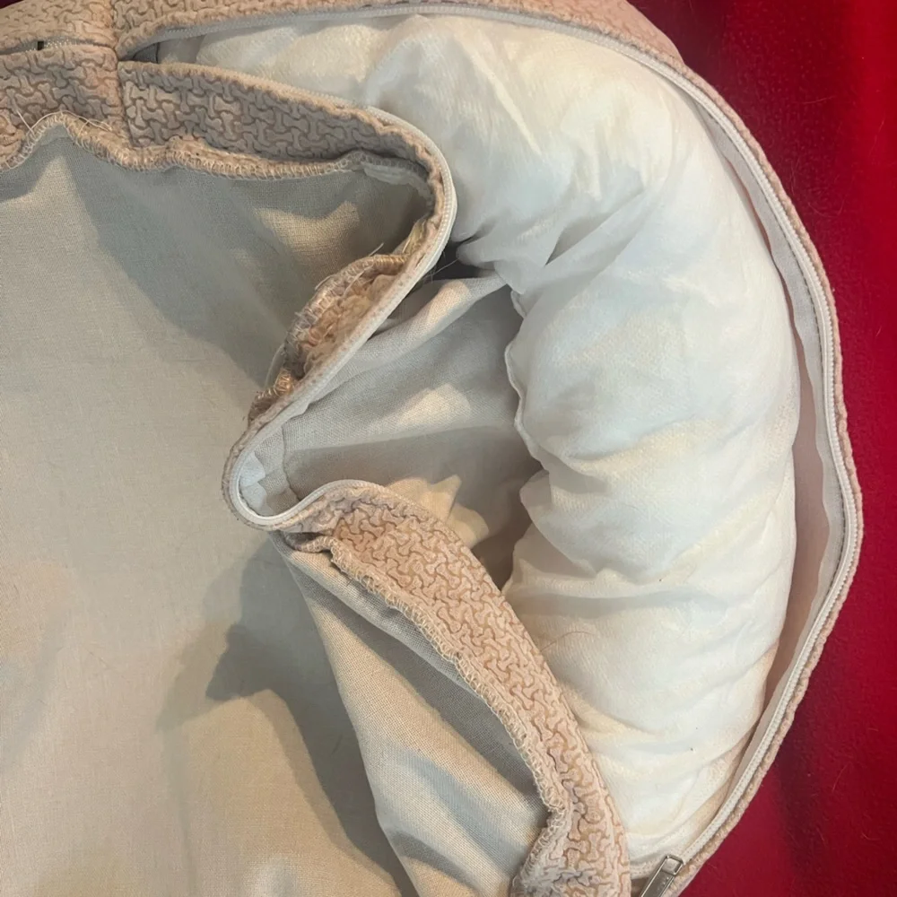 Gently used small dog or cat bed. Small round dog bed in a light color.